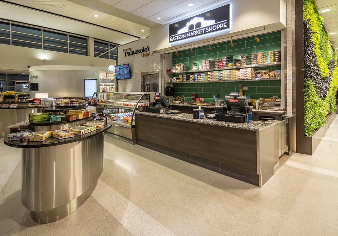 Eastern Market Shoppe counter in a modern space with displays and greenery.